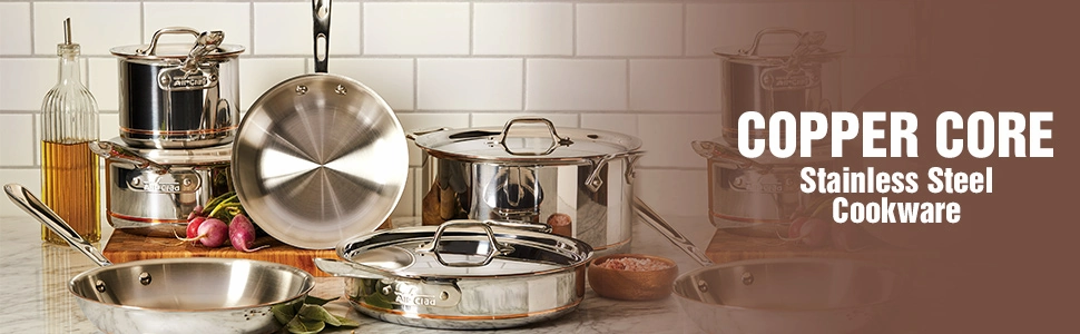 Banner publicitario de utensilios All-Clad Copper Core Stainless Steel Cookware dispuestos artísticamente en una encimera de cocina junto a ingredientes.